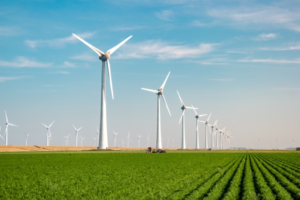 Wind turbines on green grass farm land