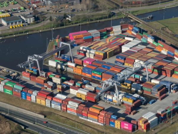 Ariel view of multi-coloured shipping containers beside a river