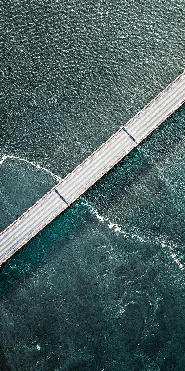 Diagonal road over turqoise water