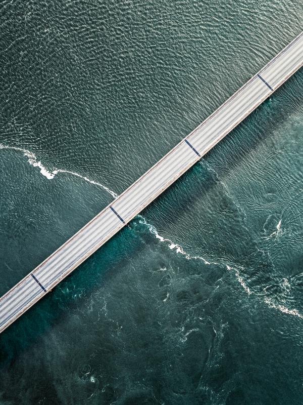 Diagonal road over turqoise water